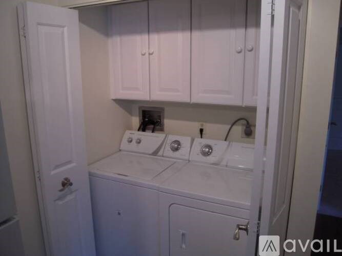A small laundry room with a washer and dryer.