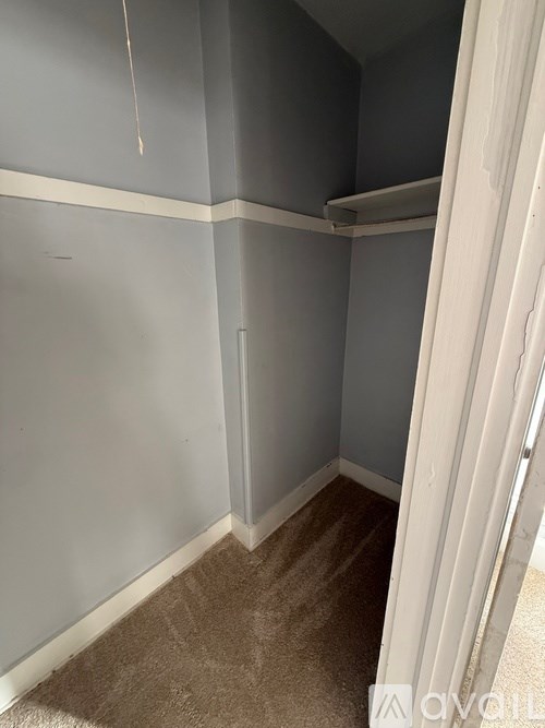 A room with grey walls and a carpeted floor.