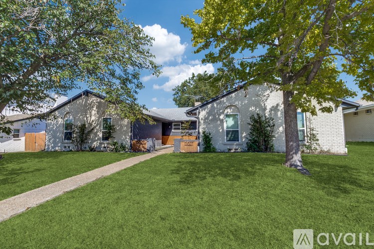 A house with a tree in front of it.