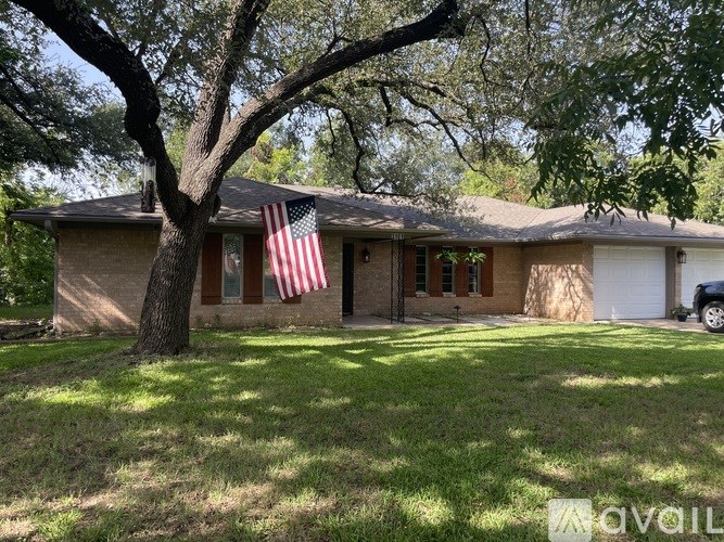 A house with an American flag hanging on the front door.