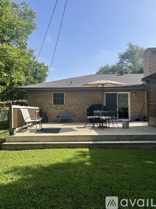 A house with a patio and a table set up outside.