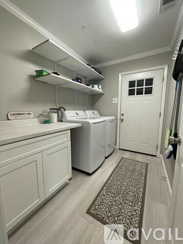 A laundry room with a washer and dryer.