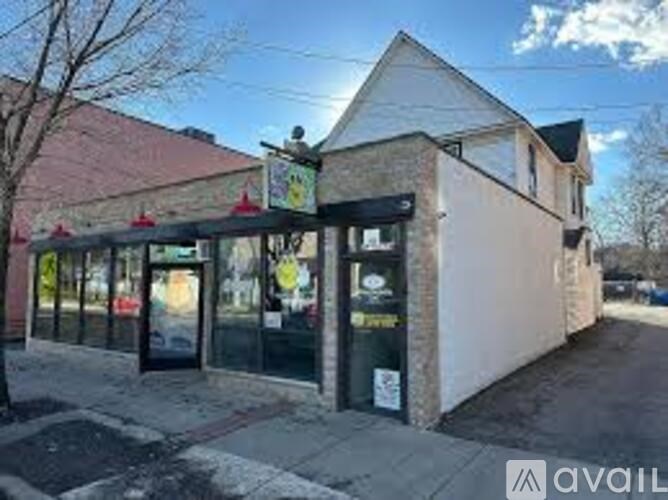 A building with a black awning and glass doors.