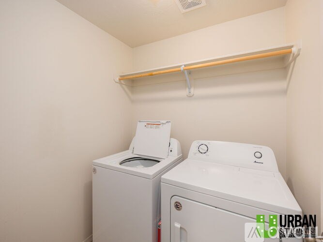 A small laundry room with a washer and dryer.