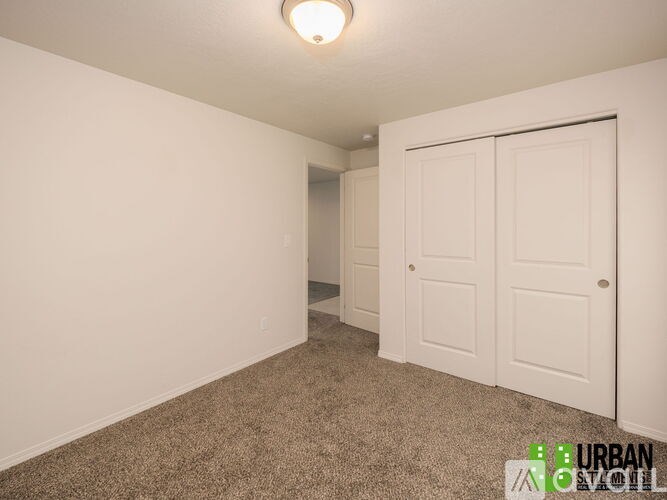 A room with two doors and a carpeted floor.