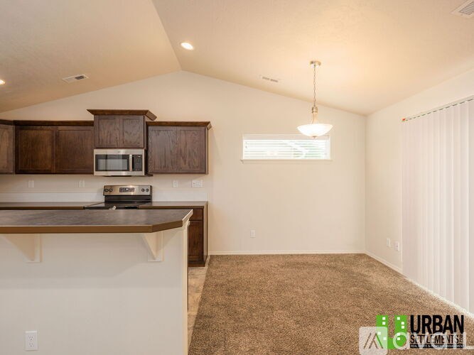 A kitchen with brown cabinets and a white countertop.