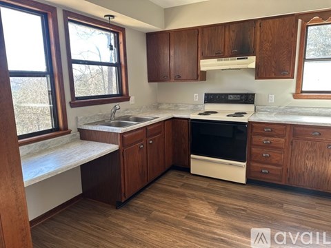 A kitchen with wooden cabinets and a white countertop.