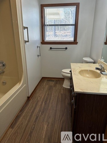 A bathroom with a toilet, sink, and tub.