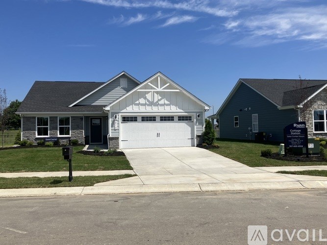 A two-story house with a garage is available for sale.