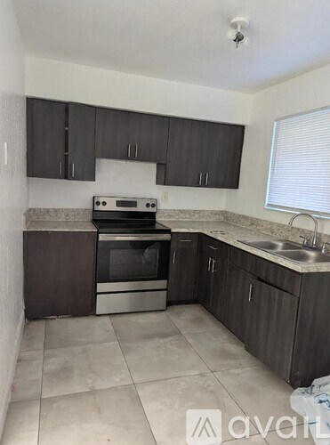 A kitchen with a stove and sink.