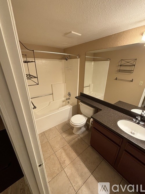 A bathroom with a toilet, sink, and bathtub.
