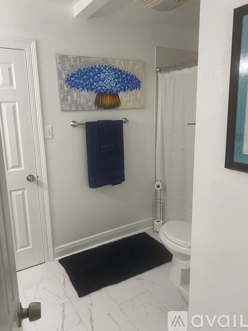 A bathroom with a towel hanging on the towel rack.
