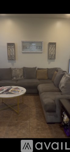 A living room with a grey couch and a coffee table.