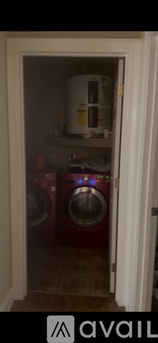 A white appliance is in a small room with a washing machine.