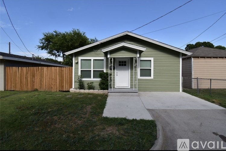 A house with a green exterior and a white door is available for rent.