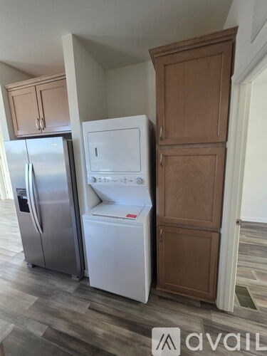 A kitchen with a white fridge and a white dishwasher.