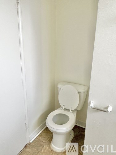 A white toilet in a small bathroom.