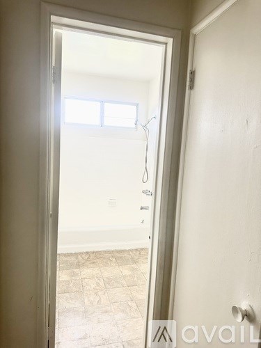 A white door with a handle and a lock is open.