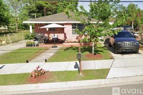 A house with a car parked in front of it.