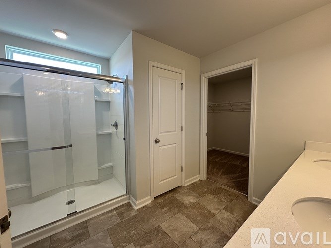A bathroom with a walk-in shower and a toilet.