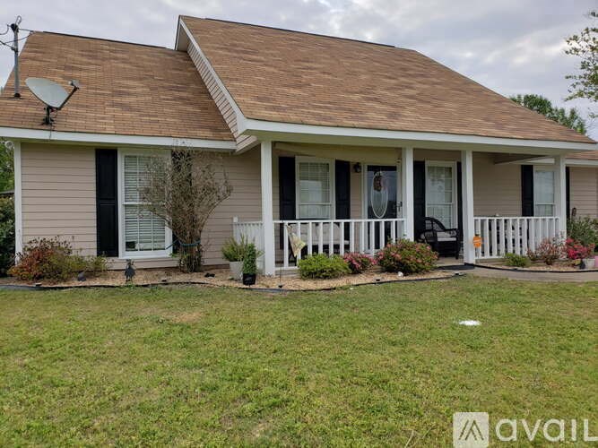 A house with a brown roof and a white fence.