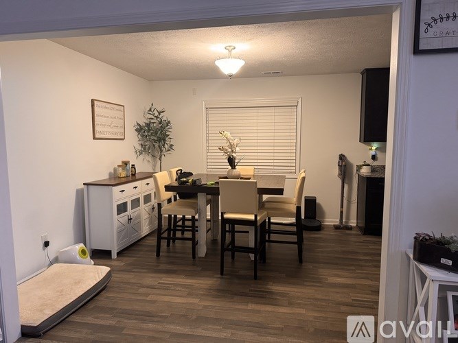 A kitchen with a dining table and chairs.