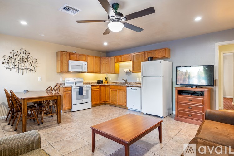 A kitchen with a dining table and chairs.