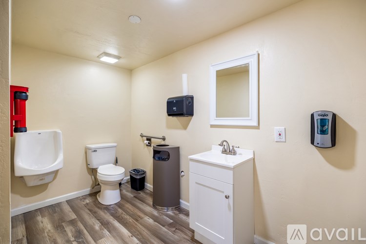 A bathroom with a toilet, sink, and urinal.
