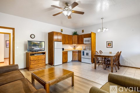 A living room with a brown couch and a wooden coffee table.