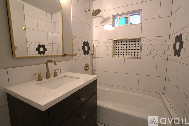 A bathroom with a white sink and a mirror above it.