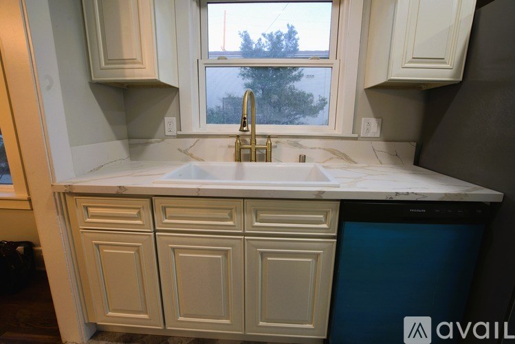 A kitchen with a marble countertop and a window.