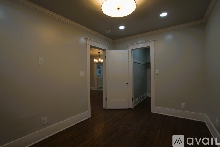 A room with a white door and a white ceiling light.