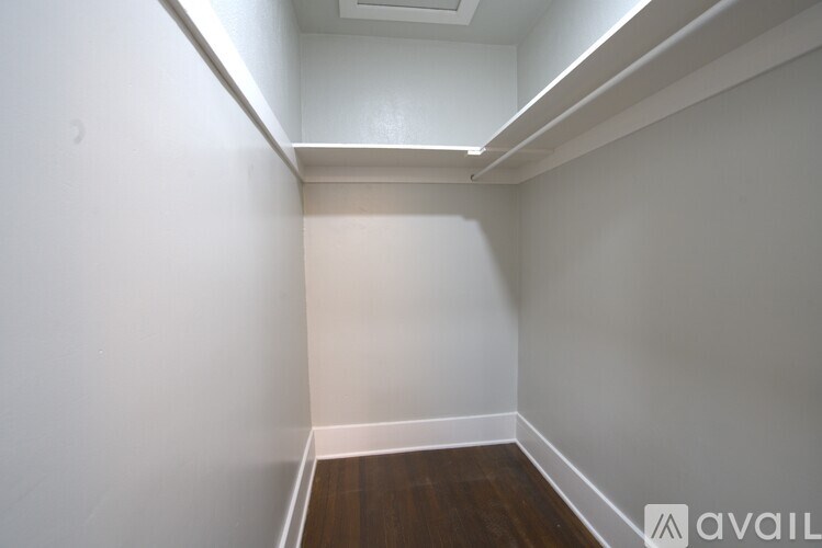 A room with a white wall and a wooden floor.