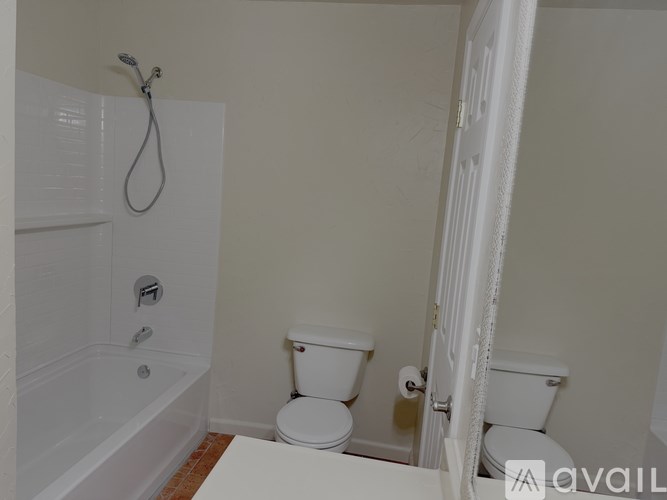 A bathroom with a toilet and a bathtub.