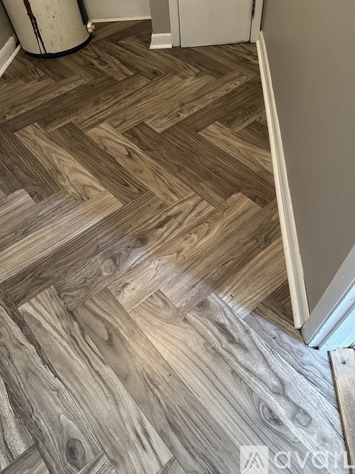 A wooden floor with a herringbone pattern is visible.