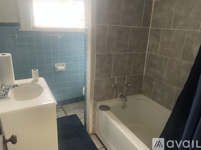 A bathroom with a white sink and a white bathtub.