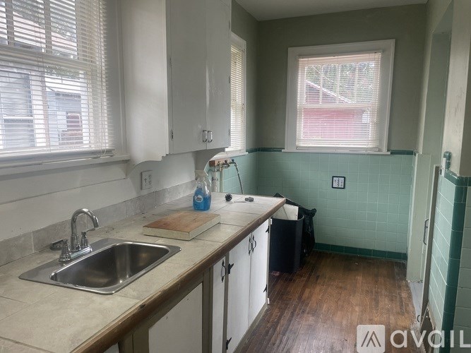 A kitchen with a sink and a window.