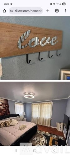 A bedroom with a bed, a nightstand, and a wooden sign that says "Love".