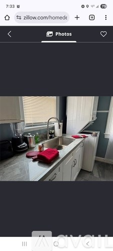 A kitchen with a red cutting board on the counter.