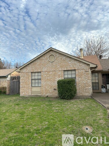 A house with a lawn in front of it.