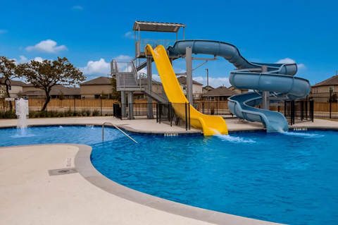 A blue and yellow water slide in a pool.
