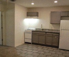 A kitchen with a white refrigerator and a white dishwasher.