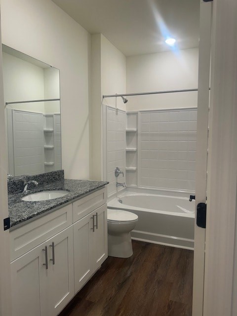 A white bathroom with a sink, toilet, and bathtub.