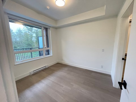 A room with a window and a door.