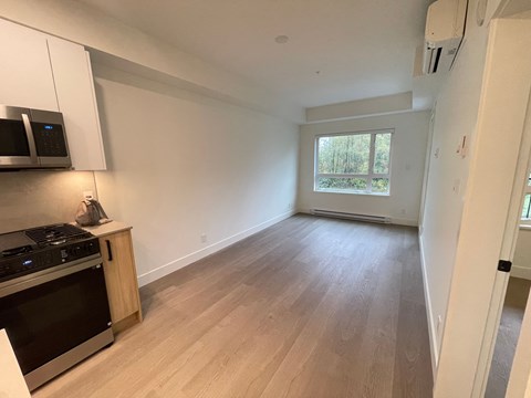 A kitchen with a stove top oven and microwave.
