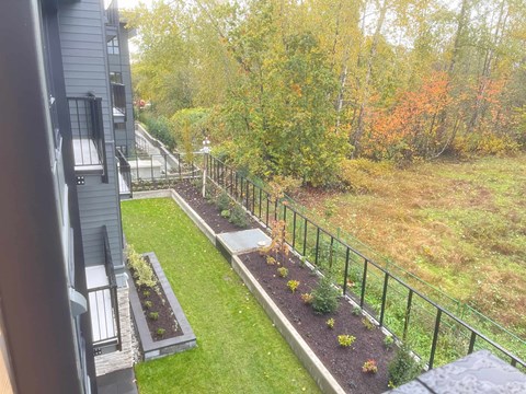 A view of a green lawn from a balcony.