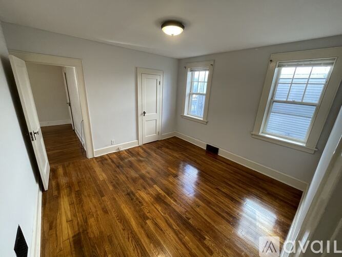 A room with wooden floors and white walls.