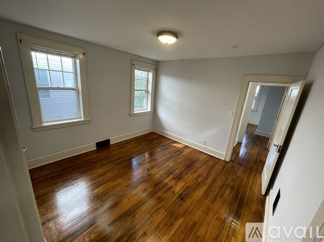 A room with wooden floors and white walls.