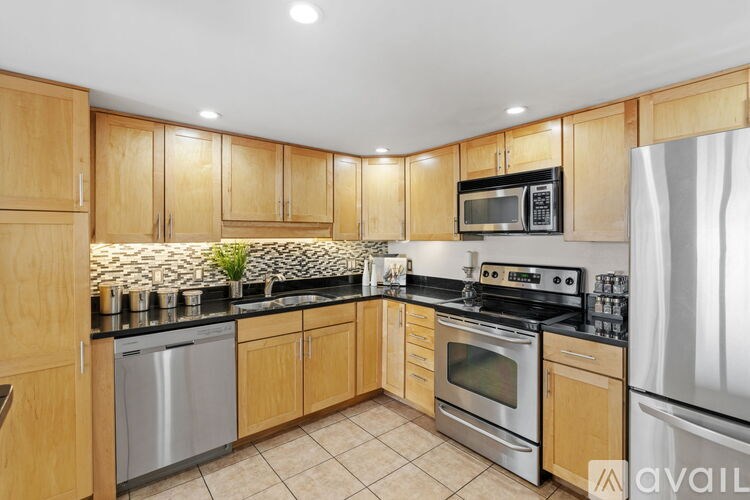 A kitchen with wooden cabinets and stainless steel appliances.