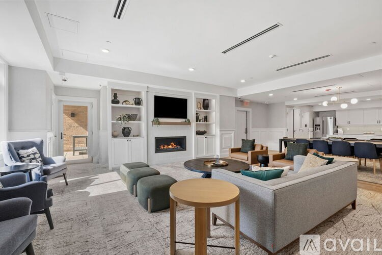 A living room with a grey couch, a wooden table, and a fireplace.